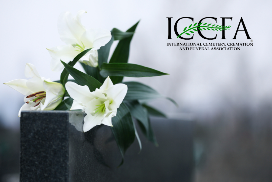 White lilies on top of gravestone with ICCFA logo in the top right corner.