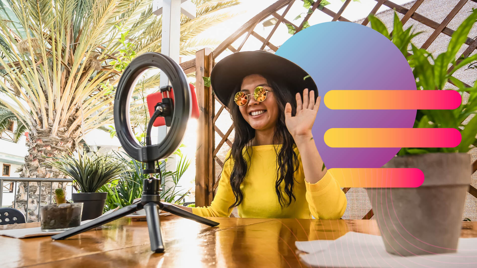 Woman in yellow shirt and hat with sunglasses sitting in front of ring light recording influencer video