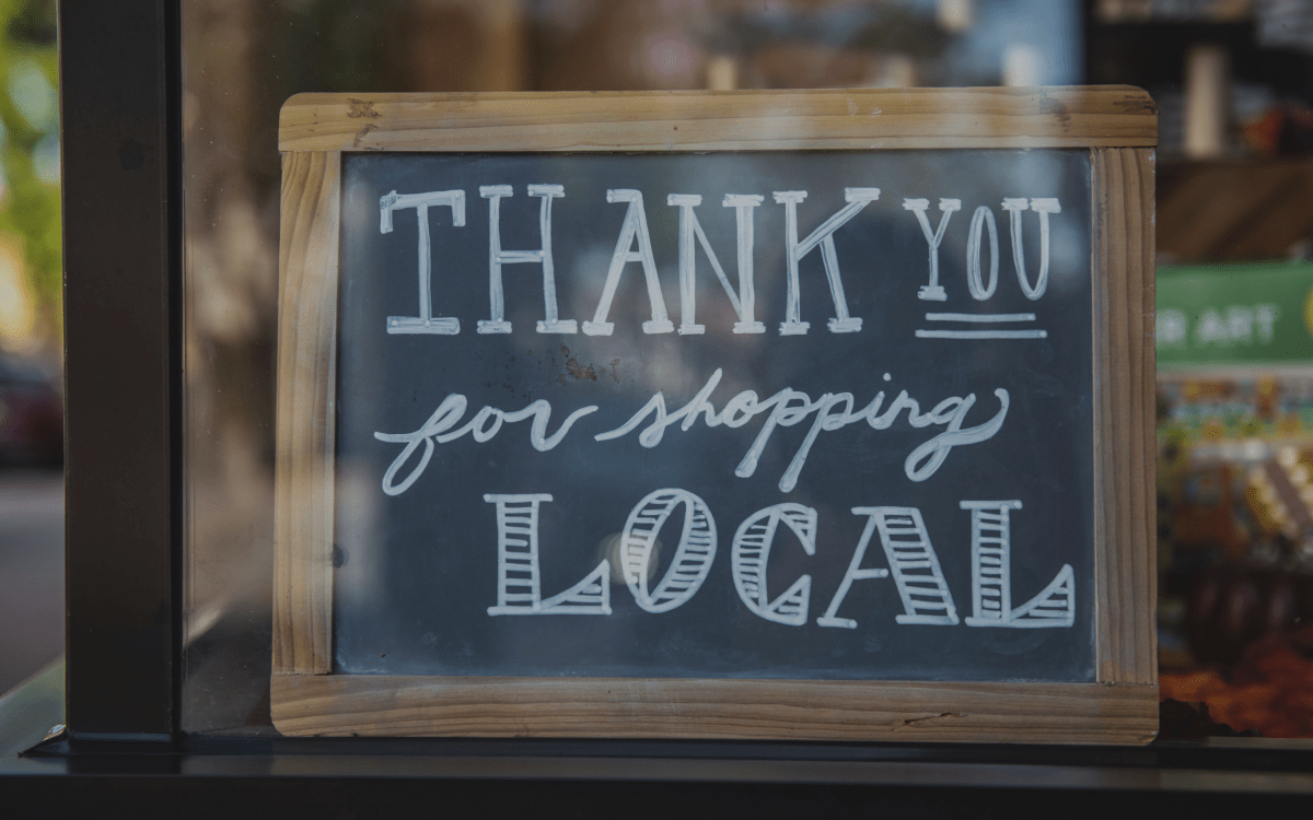 Chalkboard sign that says thank you for shopping local