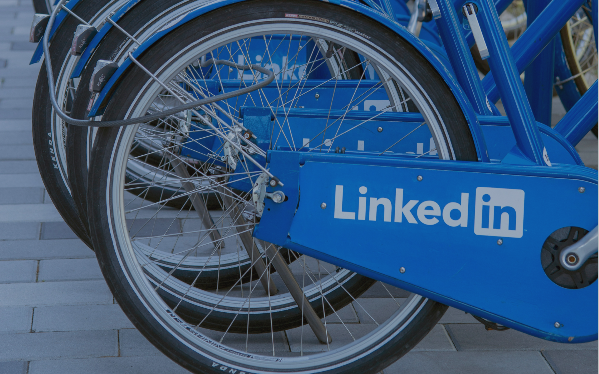 Blue bicycles with LinkedIn logo parked in a row